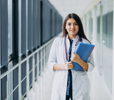 Attractive female doctor standing with documents at the hospital